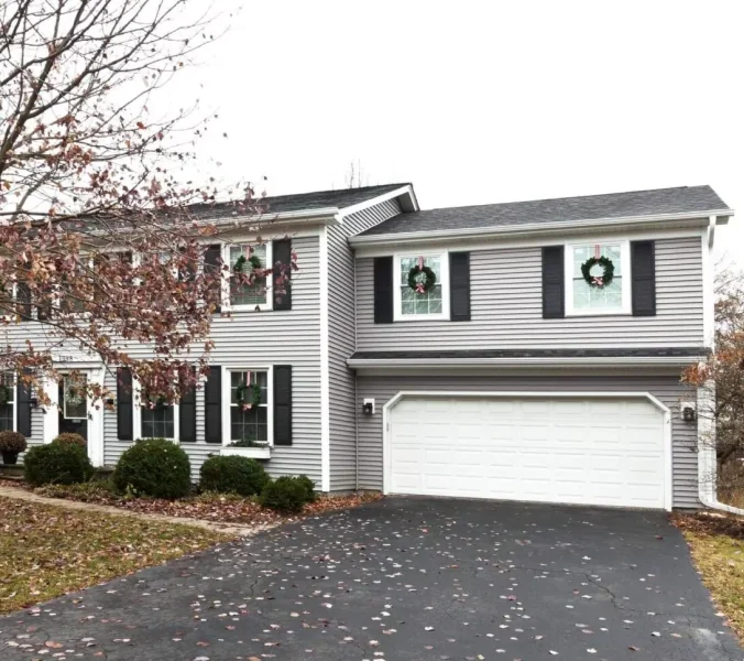 After photo of beautifully renovated gray vinyl siding house with enhanced curb appeal following Design First Builders home improvement project in Illinois