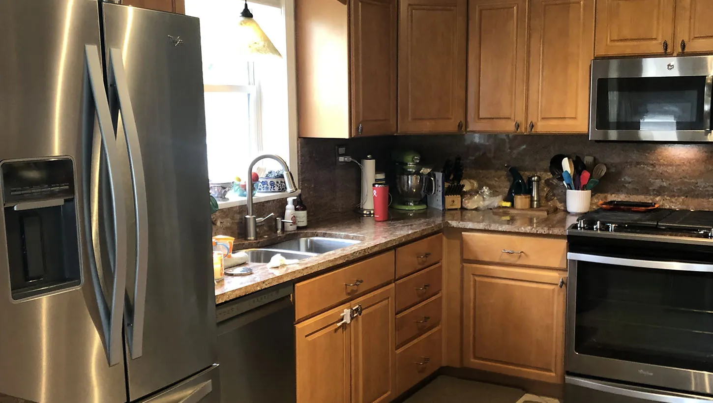 Design First Builders Lombard kitchen before renovation showing outdated honey oak cabinets, laminate countertops, and tired finishes ready for transformation