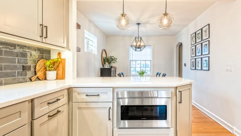 Design First Builders Park Ridge kitchen with large island, glass pendant lights, built-in microwave drawer, and open concept dining area