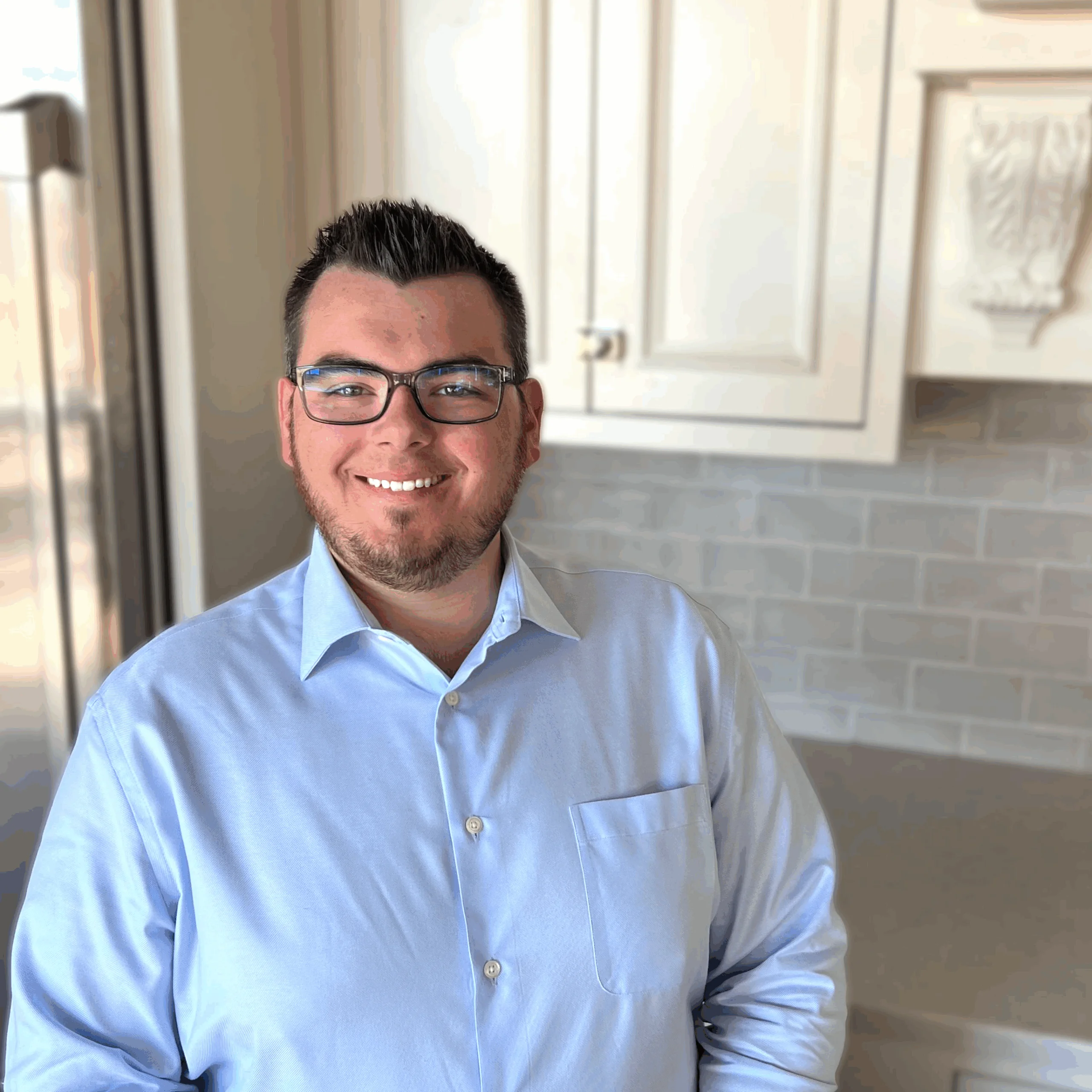Noah Glinski, Architectural Designer at Design First Builders, professional headshot in white kitchen setting in Chicago