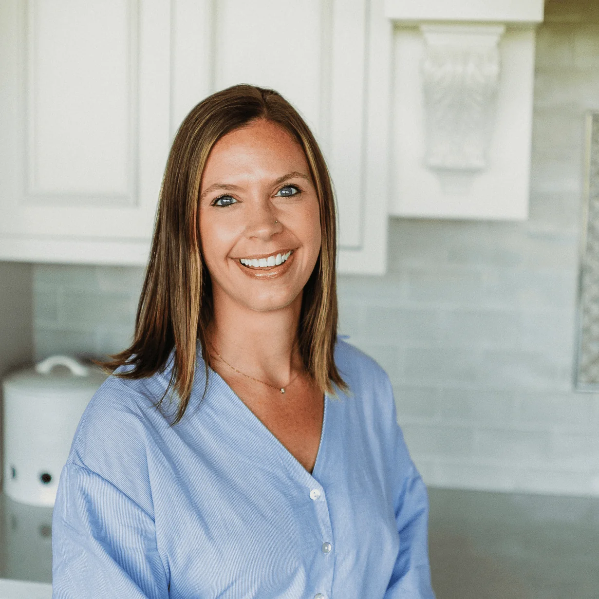 Danielle House, Senior Architectural Designer at Design First Builders, professional headshot in white kitchen setting in Chicago