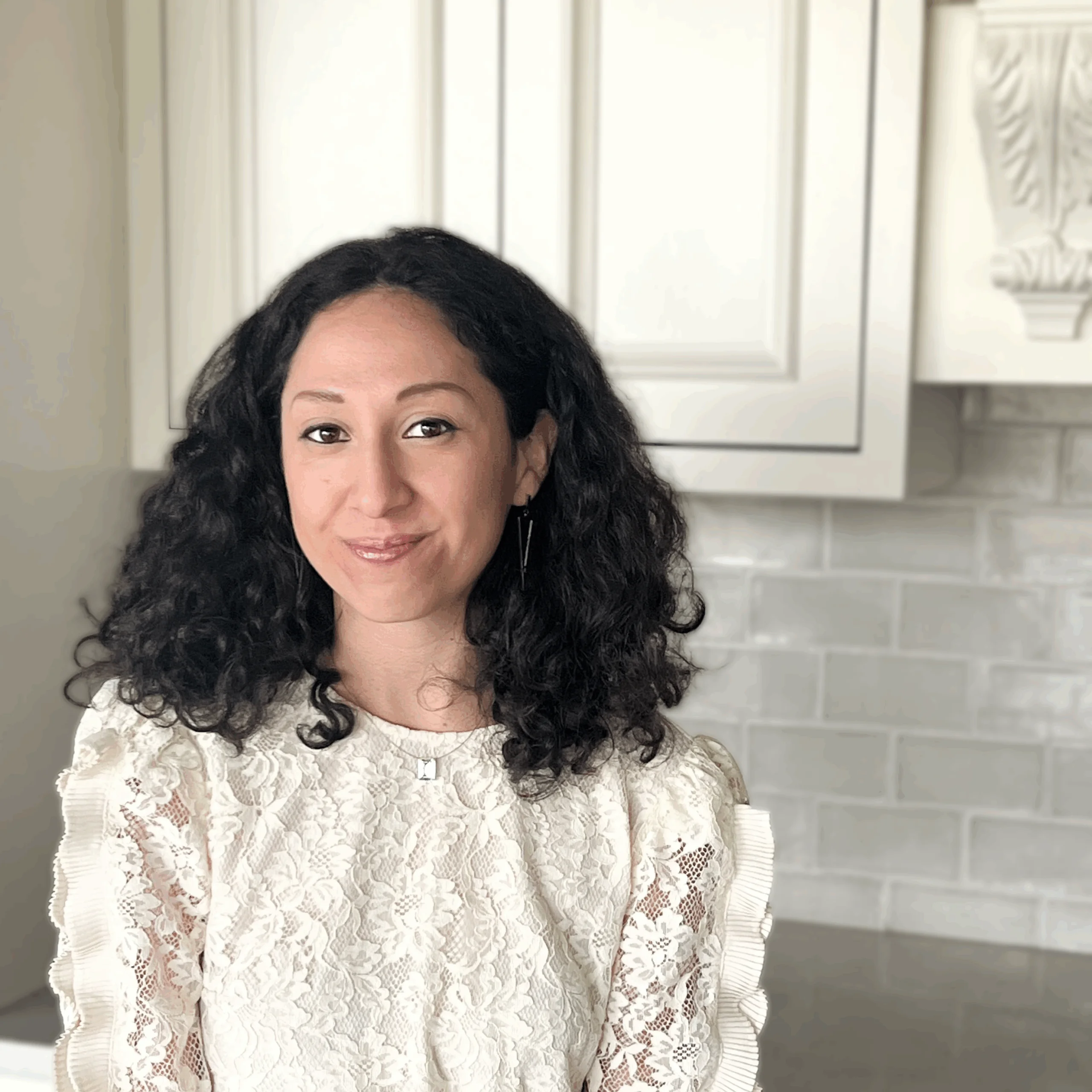 Diane Covarrubias, Design Assistant at Design First Builders, professional headshot in white kitchen setting in Chicago