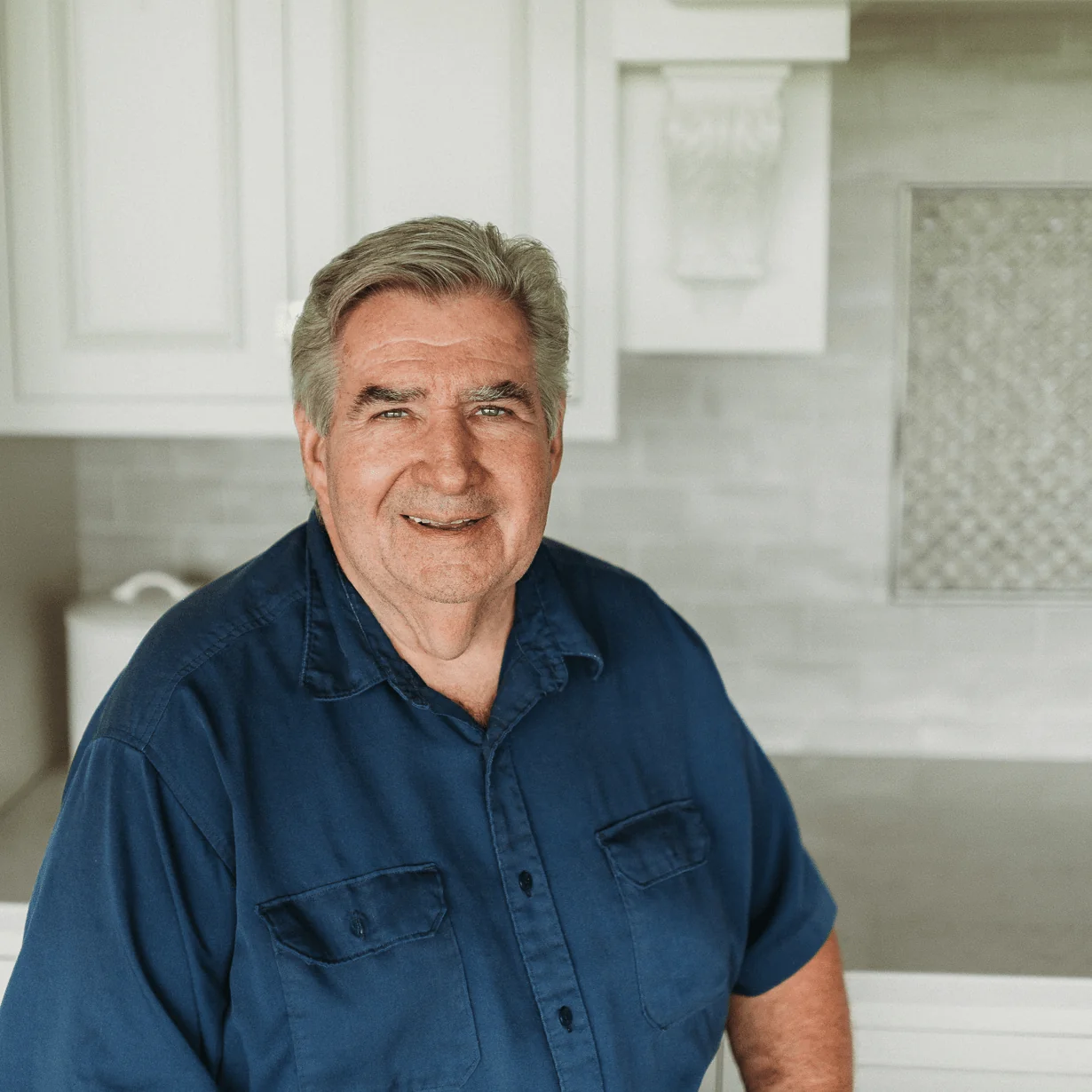 Gary Polcyn, Project Manager at Design First Builders, professional headshot in white kitchen setting in Chicago