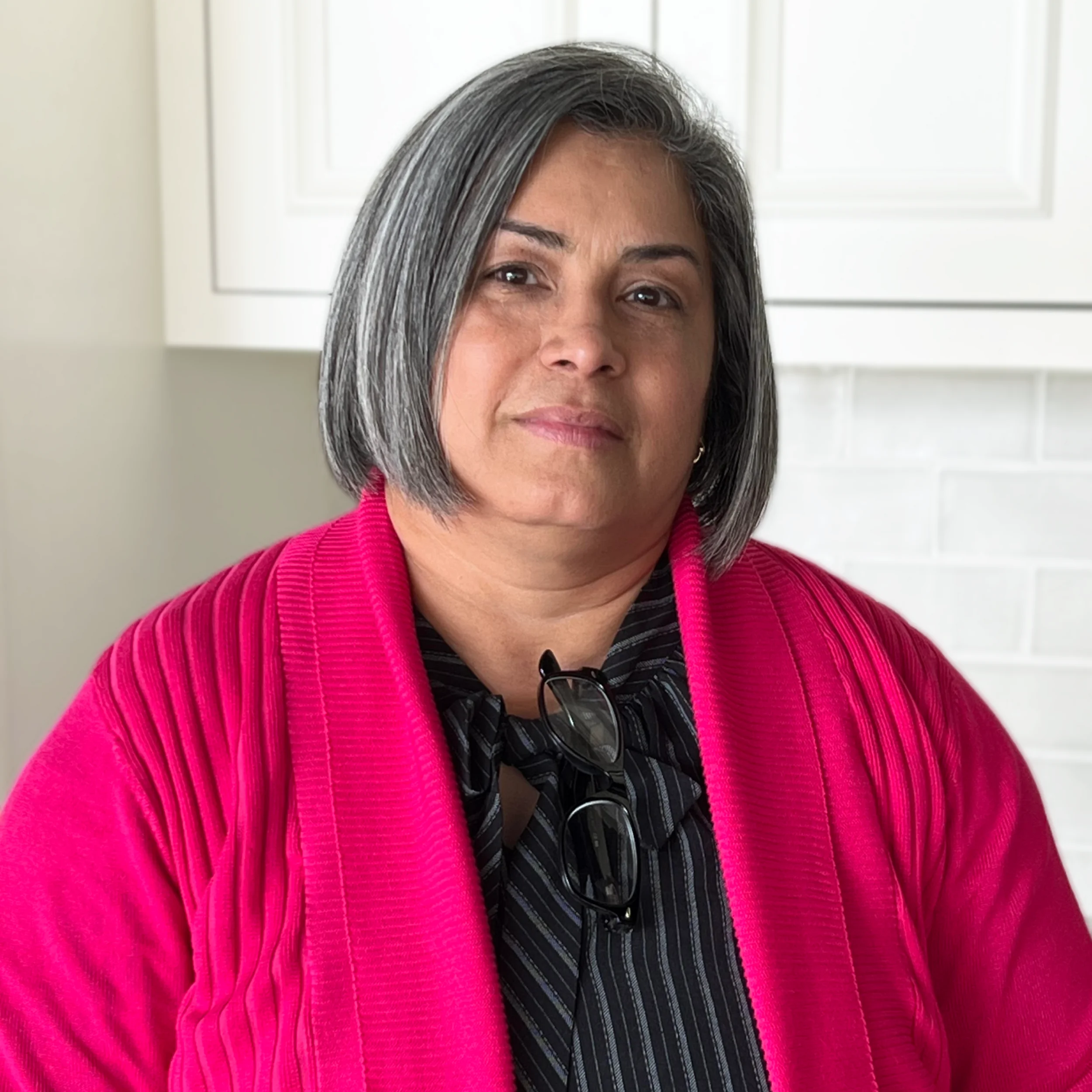 Mabel Nazario, Lead Architect NCARB RA at Design First Builders, professional headshot in white kitchen setting in Chicago