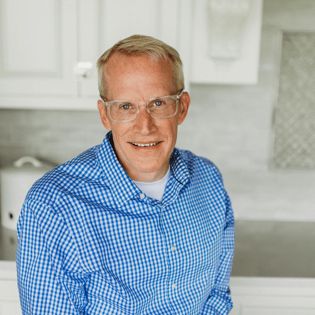 Matt Bolson, Senior Architectural Designer at Design First Builders, professional headshot in white kitchen setting in Chicago