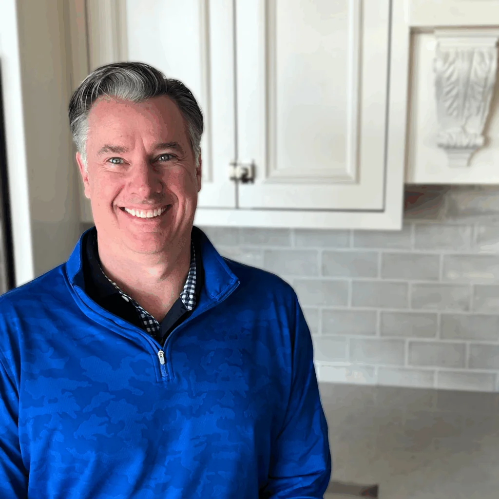 Ryan Beacom, Architectural Designer at Design First Builders, professional headshot in white kitchen setting in Chicago